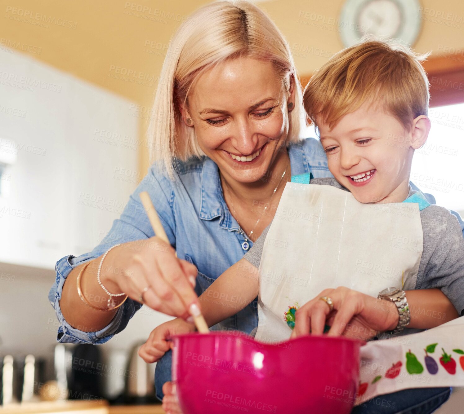 Buy stock photo Cropped shot of a mother and son baking together at home