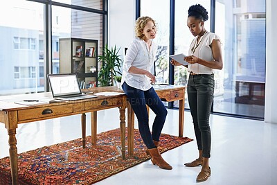 Buy stock photo Shot of two designers working together in the office