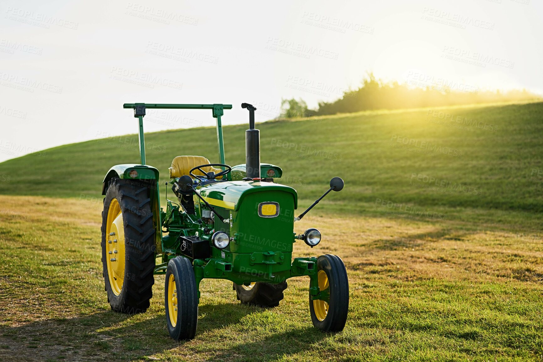Buy stock photo Shot of a tractor on an open piece of land