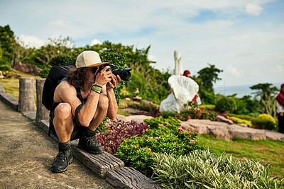 Buy stock photo Shot of a young tourist taking photos while on vacation