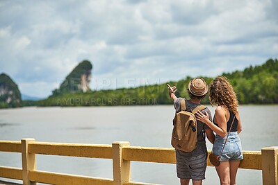 Buy stock photo Rearview shot of a young couple admiring an beautiful view while on vacation