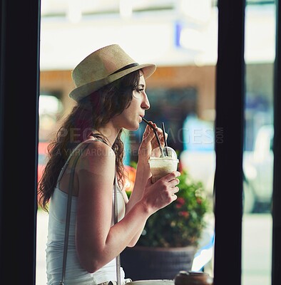 Buy stock photo Shot of a young woman enjoying a chilled coffee beverage while on vacation