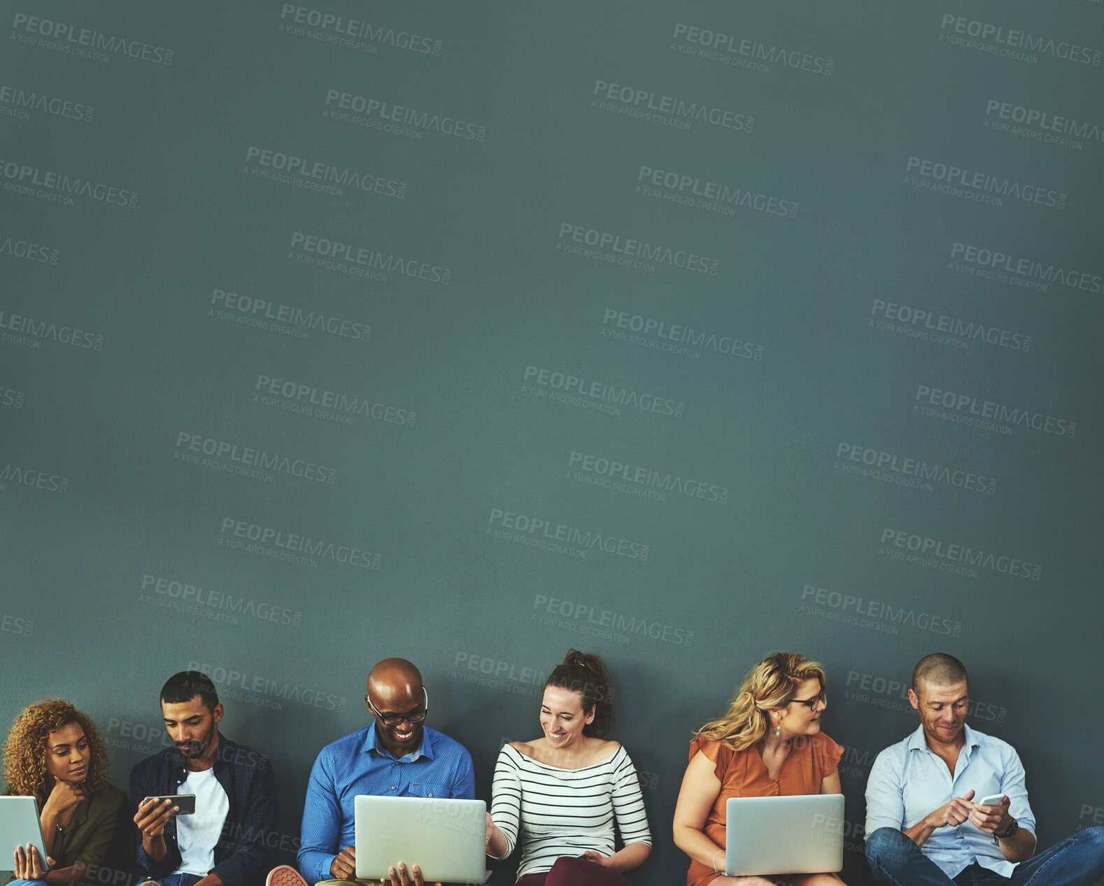 Buy stock photo Studio shot of a diverse group of people social networking against a gray background