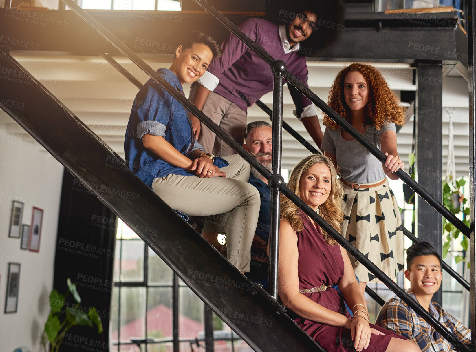 Buy stock photo Portrait of a group of diverse creative employees sitting on steps in a modern office