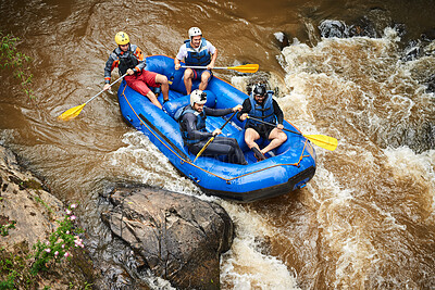 Buy stock photo High angle shot of a group of young friends white water rafting