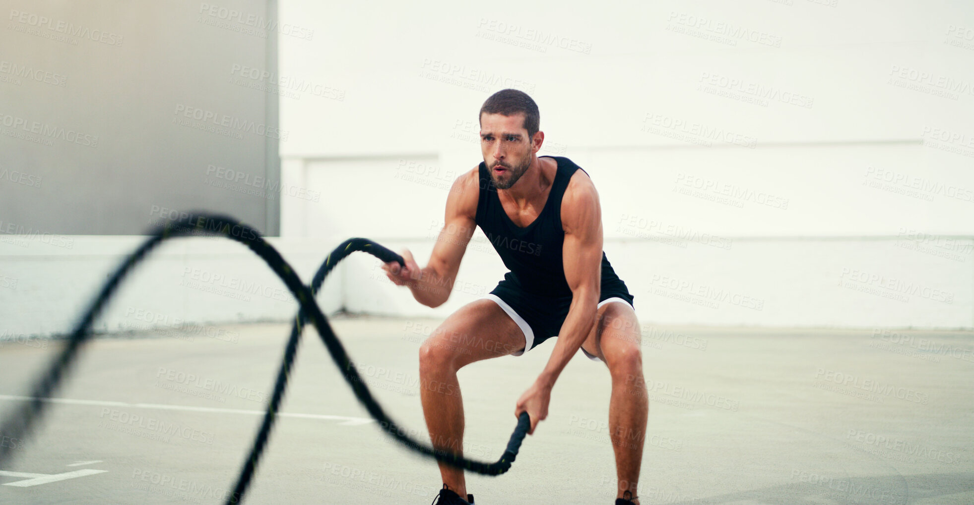 Buy stock photo Man, fitness and battle rope exercise for physical training, workout or wellness in the outdoors. Fit, active and serious male person exercising with ropes for intense endurance, stamina or cardio