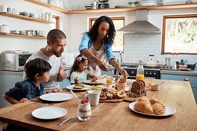 Buy stock photo Shot of a family of four enjoying breakfast together at home