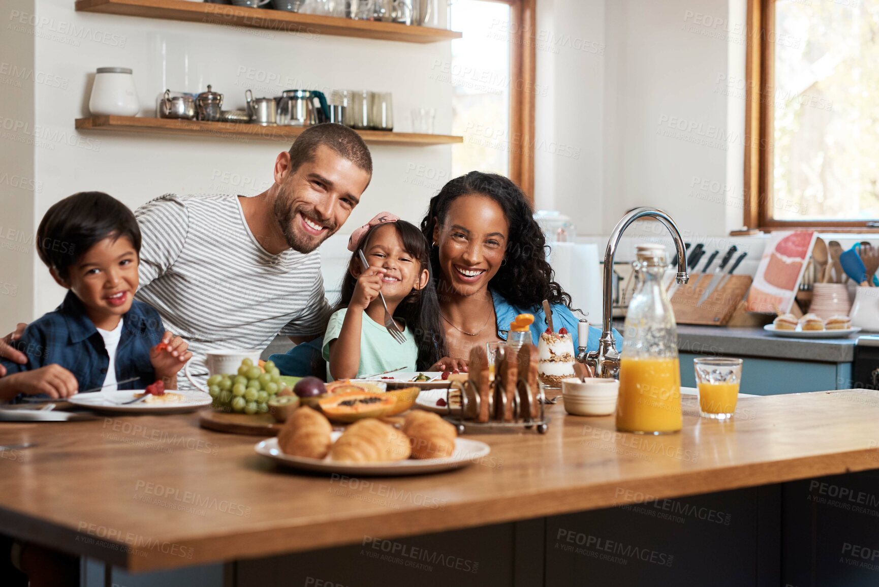 Buy stock photo Shot of a family of four enjoying breakfast together at home
