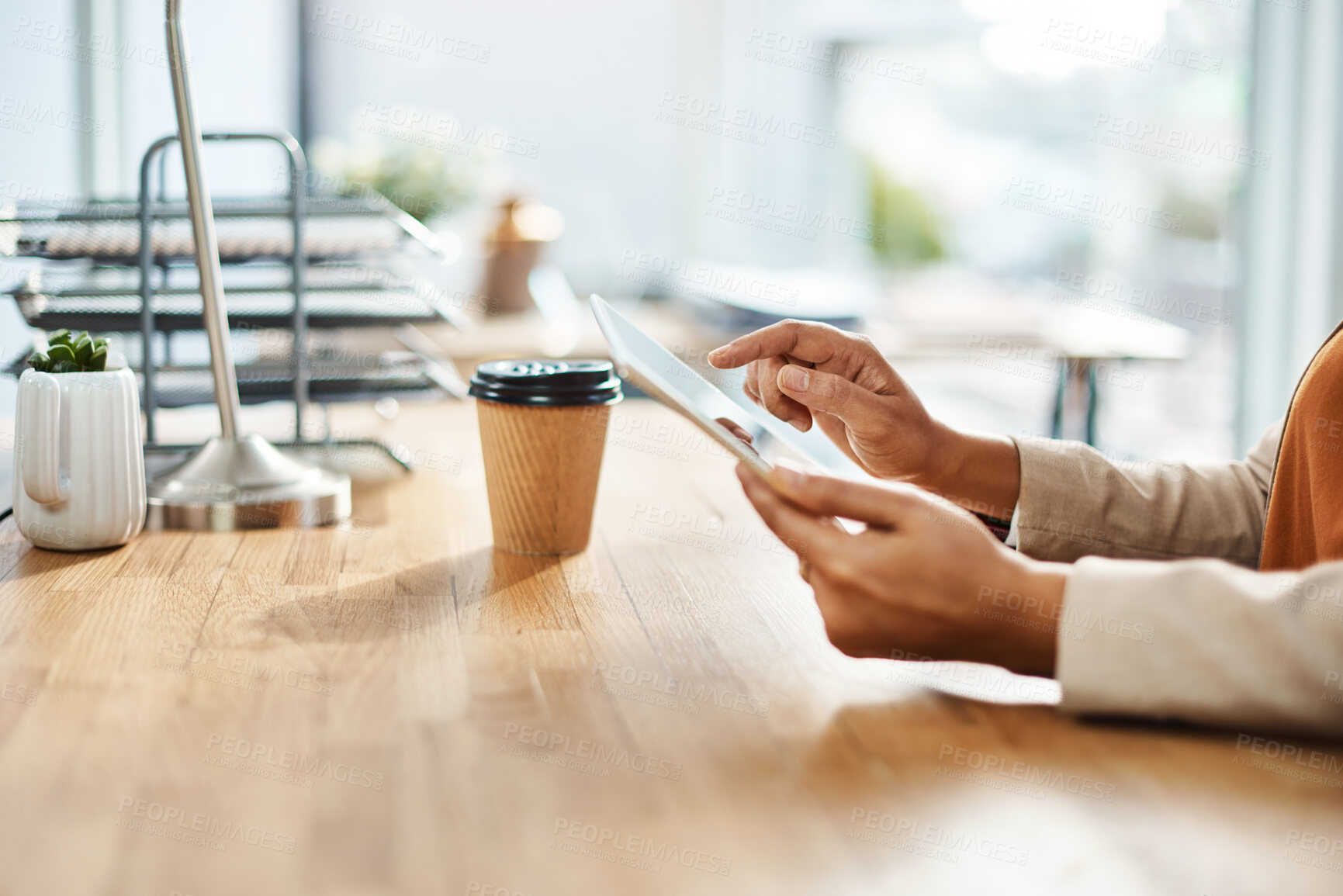 Buy stock photo Shot of an unrecognizable businesswoman using a digital tablet in her office