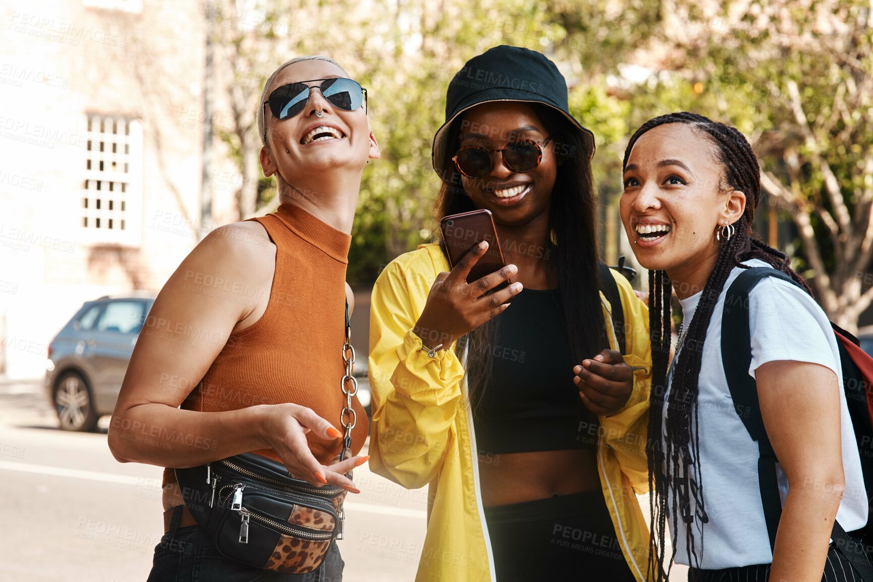 Buy stock photo Shot of three close friends spending the day together in the city