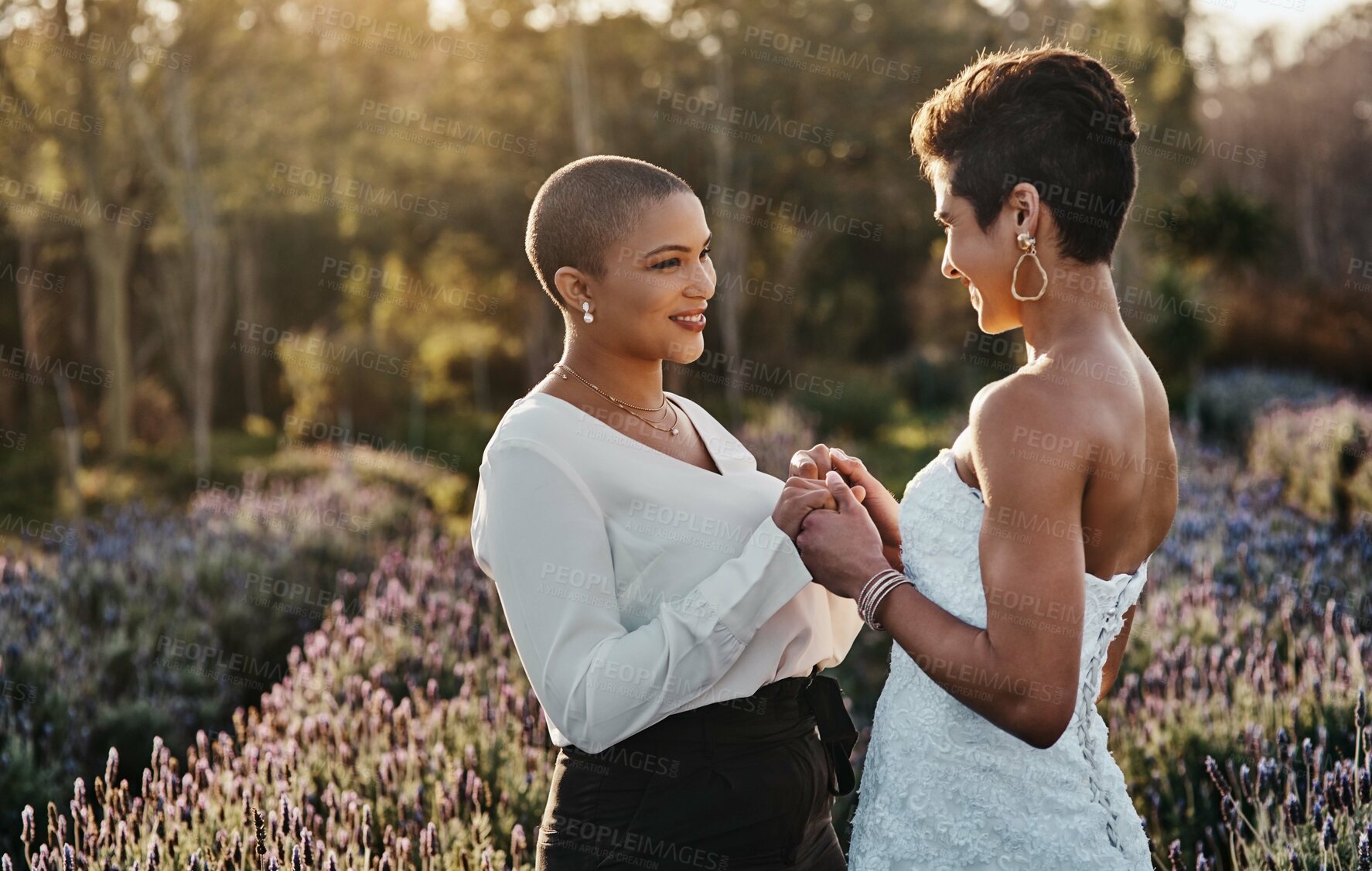 Buy stock photo Woman, lesbian couple and holding hands in marriage for wedding with smile for LGBT relationship in nature. Happy gay married women touching hand and smiling for romance, vow or loyalty outside