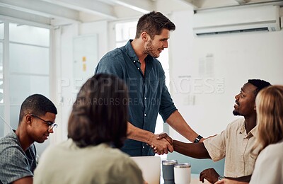 Buy stock photo Cropped shot of a diverse group of businesspeople having a meeting in the office together during the day