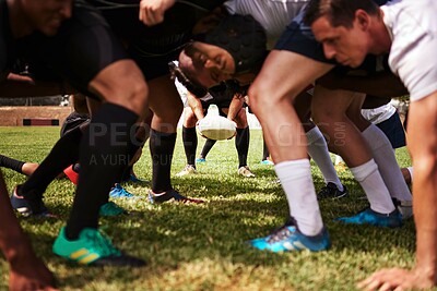 Buy stock photo Cropped shot of a group of rugby players in a scrum on the field