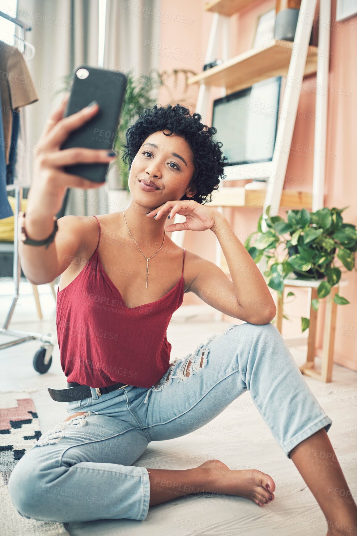 Buy stock photo Shot of a beautiful young woman taking a selfie while sitting at home