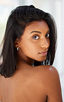 Portrait, beauty and confident with an indian woman in her home, feeling beautiful or sensual. Face, hair or relax and an attractive young female in her apartment looking back with confidence