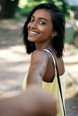 Buy stock photo Shot of a beautiful young woman walking through the park
