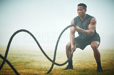 Buy stock photo Fitness, battle rope and man on field for power workout for body building, training and muscle strength. Exercise, sports and bodybuilder on grass with ropes, energy and outdoor performance challenge