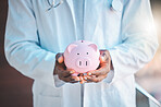 Doctor, investment or hands of person with piggy bank for financial funding, inflation or savings increase. Closeup, job or income budget in tin for future safety, medical aid or insurance security