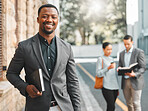 Businessman, portrait and book in city street with happiness for corporate career in law and knowledge on justice. Attorney, african person and face with smile, confidence and pride in urban road