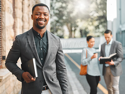 Buy stock photo Businessman, portrait and book in city street with happiness for corporate career in law and knowledge on justice. Attorney, african person and face with smile, confidence and pride in urban road