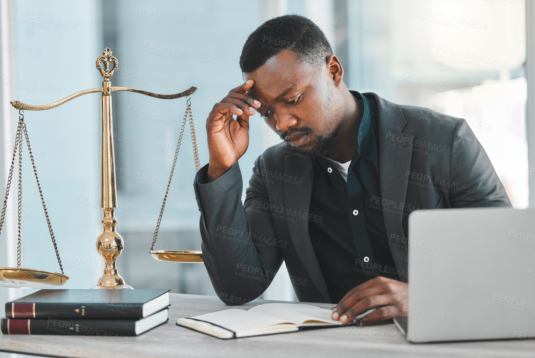 Buy stock photo Man, lawyer and stress for notes in office, read and worry for legal constitution or justice. Black male person, laptop and information for research on court case, anxiety and advocate for solution