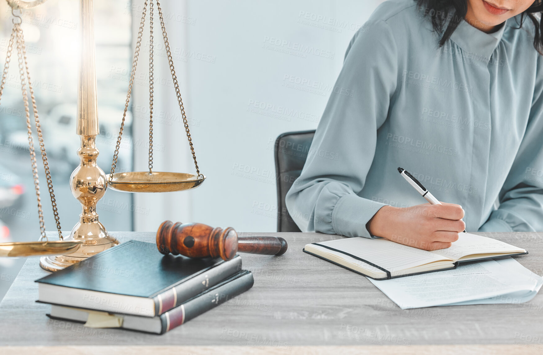 Buy stock photo Writing, planning and hands of a lawyer at office desk with notes for legal research, ideas or brainstorming at law firm. Woman or attorney with notebook for justice, policy and human rights by scale