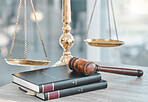 Justice, gavel and scale with law books on table at firm for court trial, balance or fair constitution by judicial system. Legislation, closeup or legal hammer in advocate office for tribunal in room