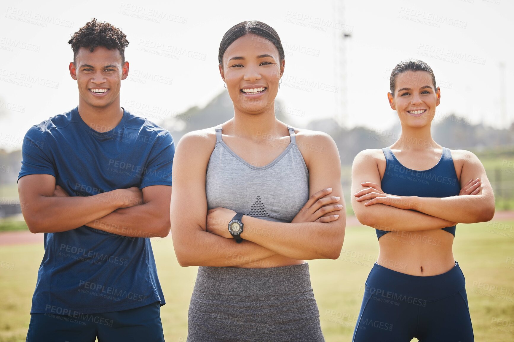 Buy stock photo Cropped portrait of three young athletes standing outside with their arms folded