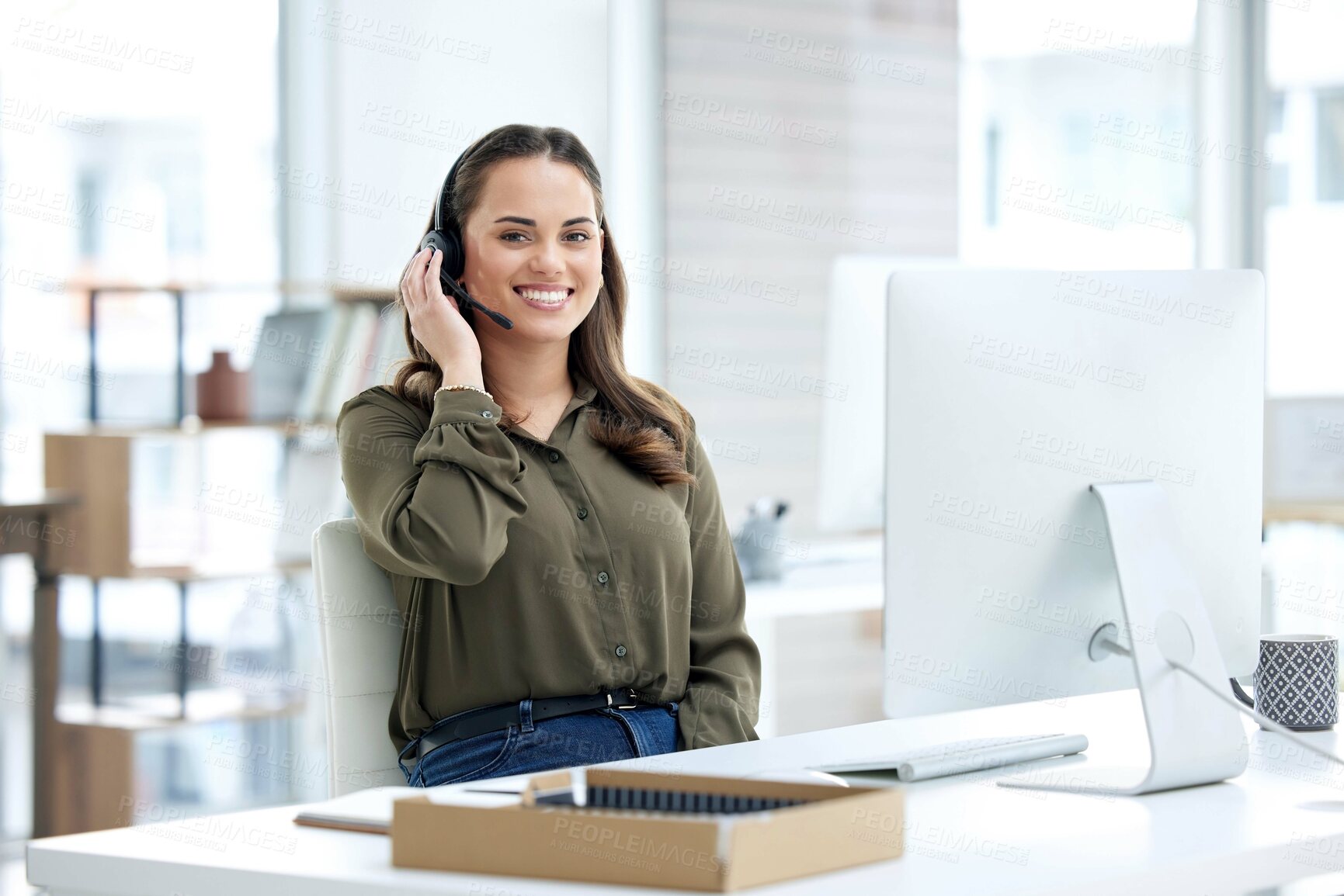 Buy stock photo Portrait of a young businesswoman using a headset and computer in a modern office