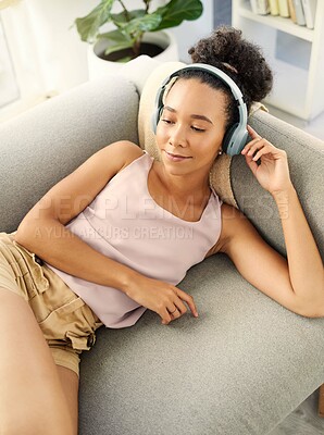 Buy stock photo Relax, music headphones and woman on sofa in home living room for streaming. Hip hop, couch and African person listening to radio, audio or podcast, jazz song and sound for thinking alone in house.