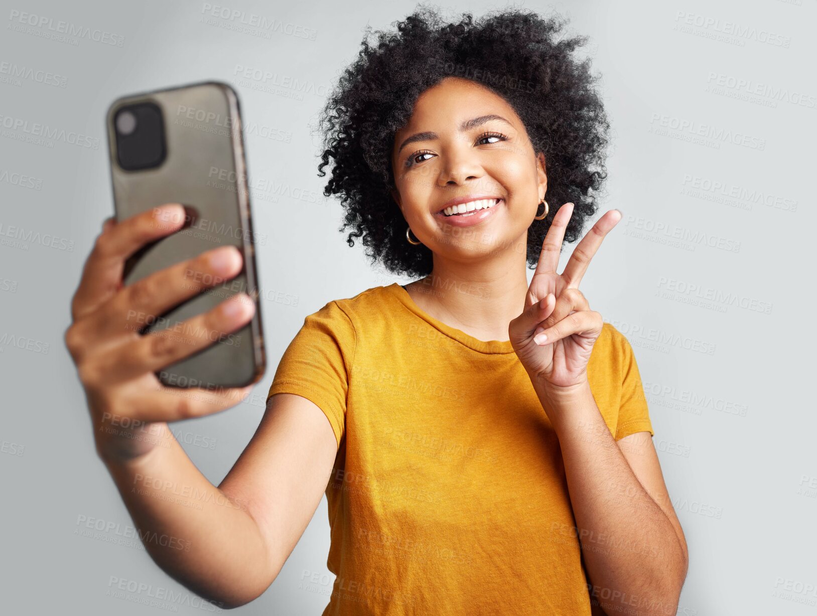 Buy stock photo Peace sign, selfie and smile with woman in studio for social media, connection and profile picture. Happy, emoji and technology with female on white background for online update, trendy and gen z