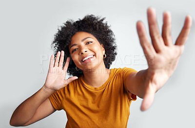 Buy stock photo Portrait, young woman and posing with hand on ear gesture smiling or being cheerful with wide open palm on grey studio background. Model, natural and pose for happiness or excitement 