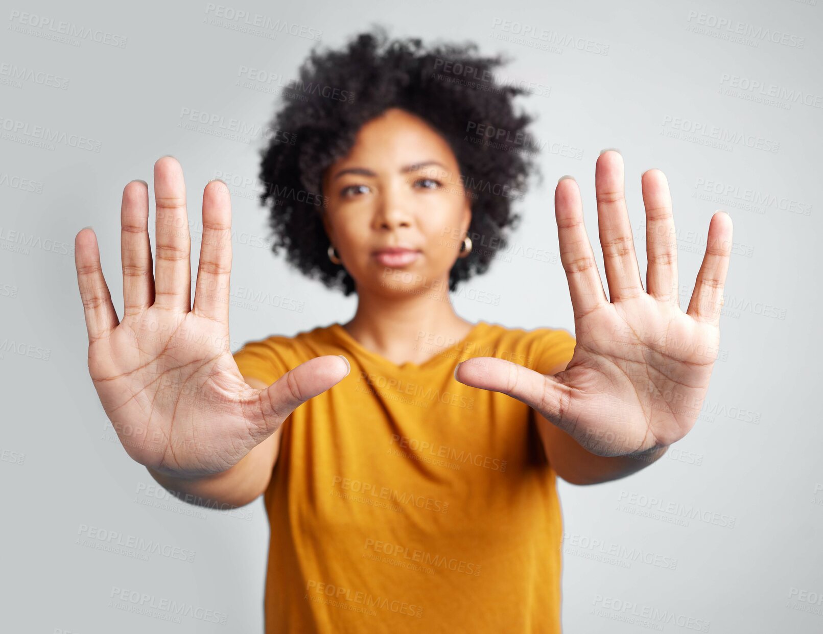 Buy stock photo Portrait, hands and warning with a woman in studio on a gray background for control or to stop abuse. Palm, protest and body language with an attractive young female person saying no in disagreement