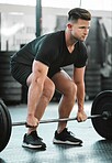 Fit, active and strong man with barbell weight for lifting in gym workout, exercise and training. Serious, motivated and sporty athlete building muscle, cardio health and endurance in wellness centre