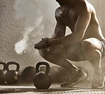 Fitness, workout of healthy wellness man at a gym. Big muscular male getting ready for weight lifting, preparing by clapping hands with powder dust. Fit, strong and athletic bodybuilder guy training.