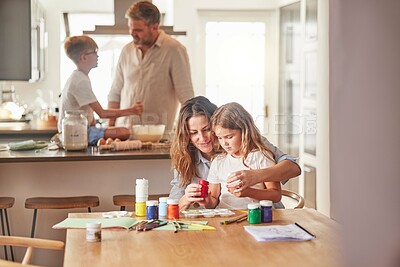 Buy stock photo Mother painting with child and father cooking with kid in their family home together for growth development and learning. Parents or people teaching children, having fun in kitchen or a holiday house