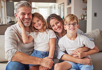 Buy stock photo Happy, smile and portrait of a family relax in the living room bonding on the sofa together. Happiness, care and parents sitting and holding their children with love on a lounge couch at home