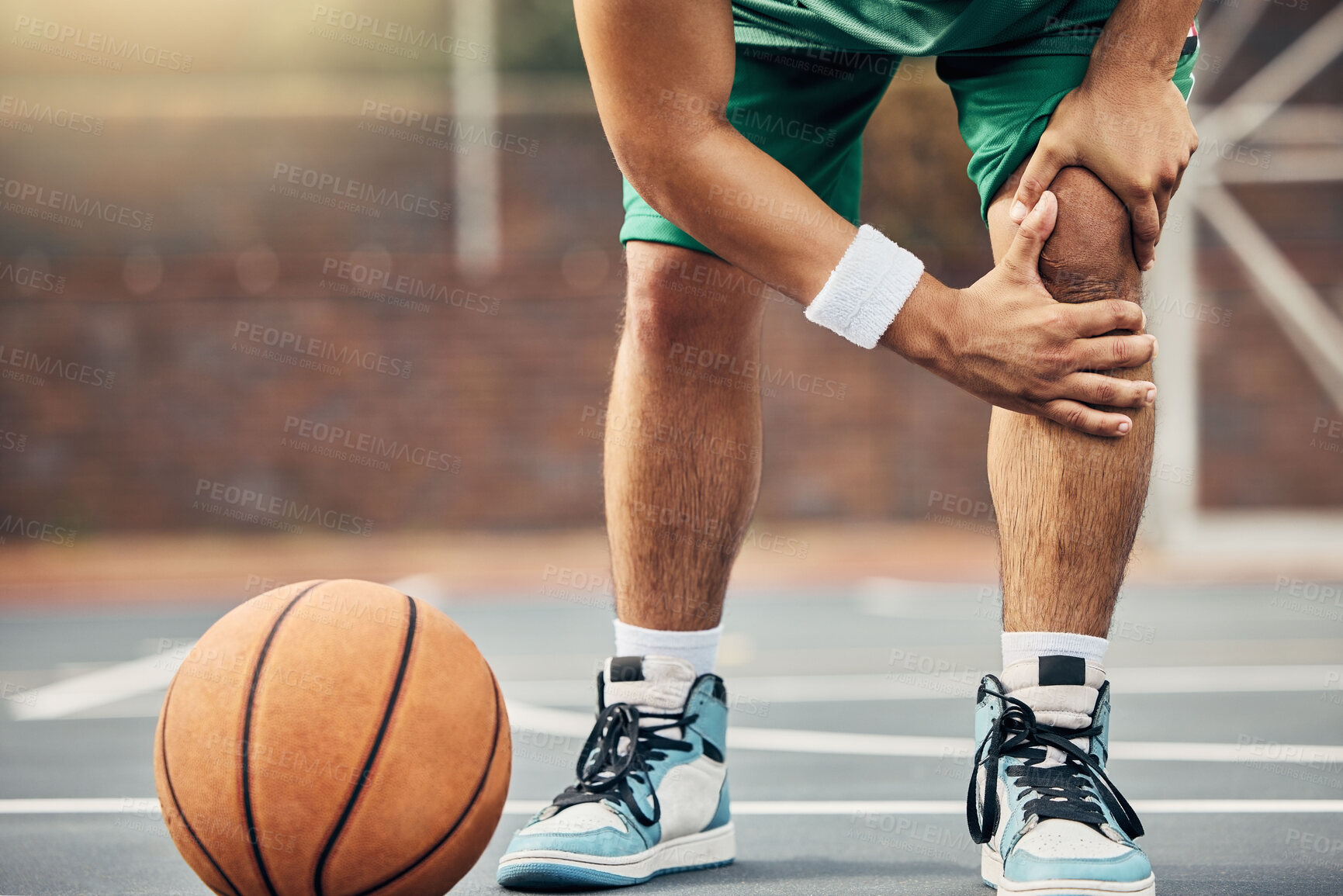 Buy stock photo Basketball, athlete and knee injury on the basketball court during outdoor game or training. Man in with leg pain after sports accident with a broken joint, inflammation or muscle tear during match.