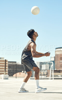 Buy stock photo Training, soccer and man with ball in air trick on city rooftop in Brazil for outdoor playing. Football, workout and athlete male practicing technique with focus, concentration and dedication.