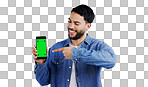 Man, cellphone or pointing to green screen in portrait, mockup space or happy for advertising. Arab person, smile or face in marketing of tracking markers, mobile app or contact by white background