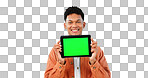 Portrait, smile and man with tablet, green screen and promotion on a blue studio background. Face, person and model with technology, internet and presentation with mockup space, news and digital app