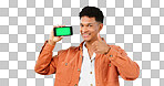 Thumbs up, green screen phone and portrait of man on blue background for promotion, approval or thank you. Emoji, social media and person with hand sign for agreement, mobile app or website in studio