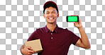 Courier man, phone and green screen in studio for smile, mockup space or box by blue background. Supply chain expert, cardboard package and smartphone for app promotion, chromakey or tracking markers