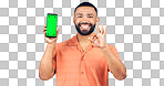 Portrait, man and okay for phone with green screen, space and agreement sign in studio on white background. Happy model, smartphone and yes emoji for certified news, promotion or advertising feedback