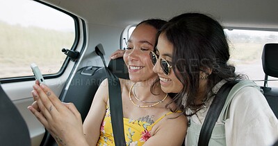 Buy stock photo Couple of friends, mobile and car for road trip information, location search and social media. Happy women scroll on phone or app talking of travel, holiday and transportation service with funny chat