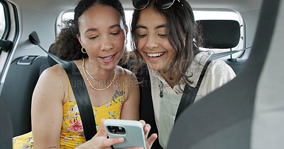 Happy friends, phone and car for road trip information, location search and social media. Young women reading on mobile app and talking of travel, holiday and transportation service with funny chat