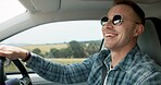Happy man, car and driving for road trip, travel or outdoor adventure in the countryside. Young male person or driver smile in vehicle for transportation, journey or vacation on street or asphalt