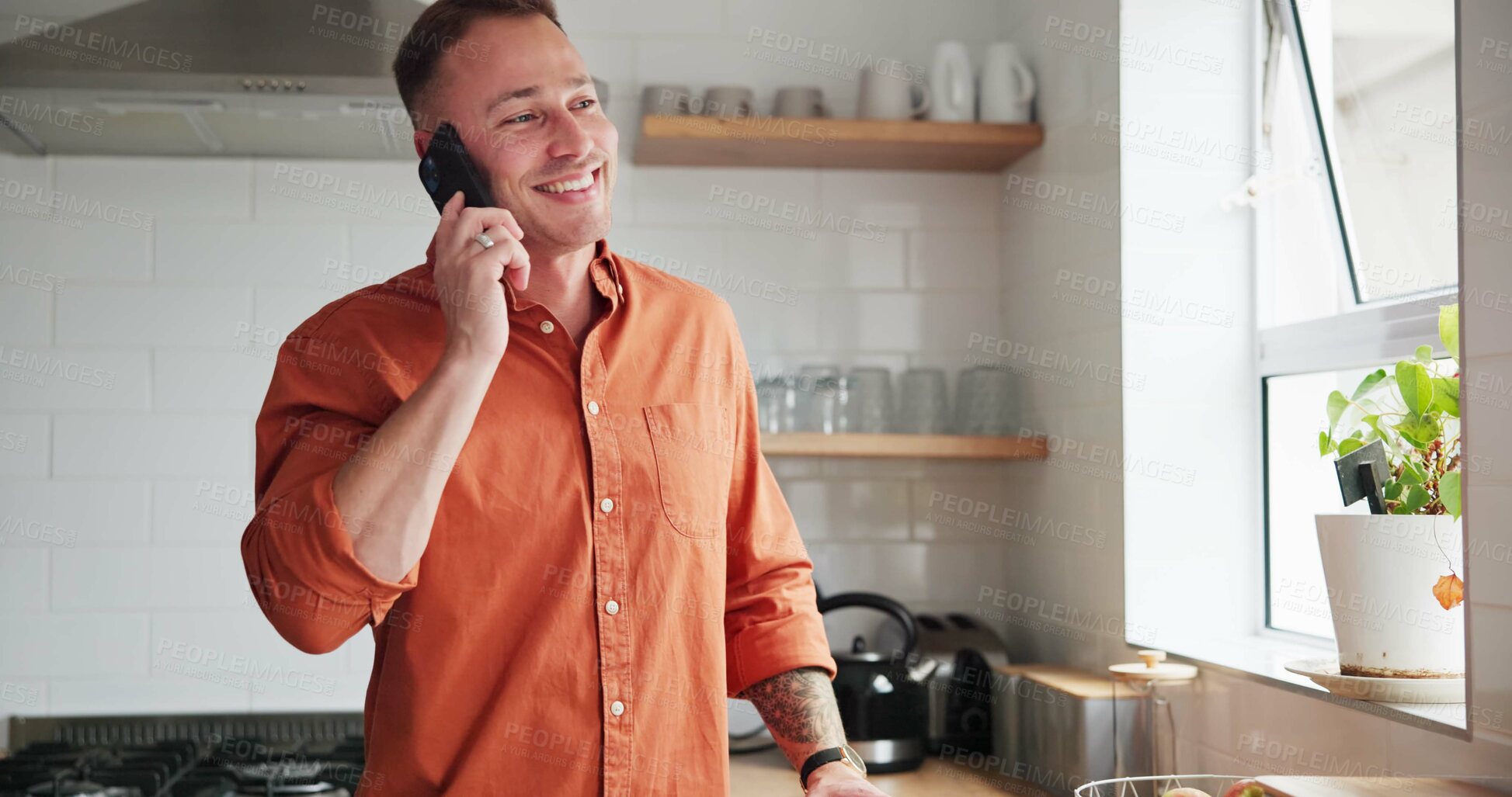Buy stock photo Man, kitchen and phone call or conversation at home, happy and relaxing in apartment. Male person, communication and mobile application for funny online conversation, humor and laughing on smartphone