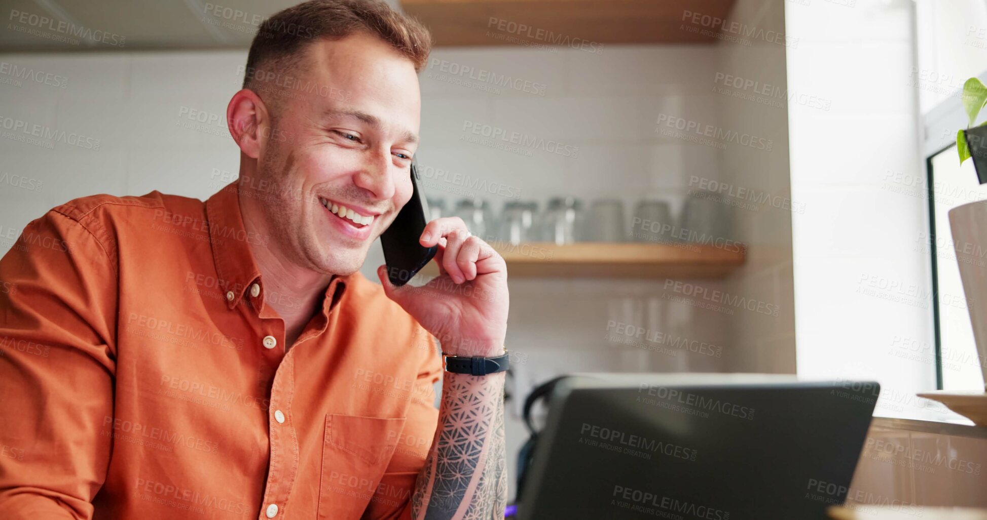 Buy stock photo Man, freelancer and laughing on phone call at home, happy and networking in kitchen. Male person, communication and mobile application for online conversation, laptop and remote work or research