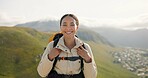 Happy woman, face and backpack with mountain for hiking, adventure or outdoor journey in nature. Portrait of female person, tourist or hiker smile with bag for trekking or climbing on cliff or hills